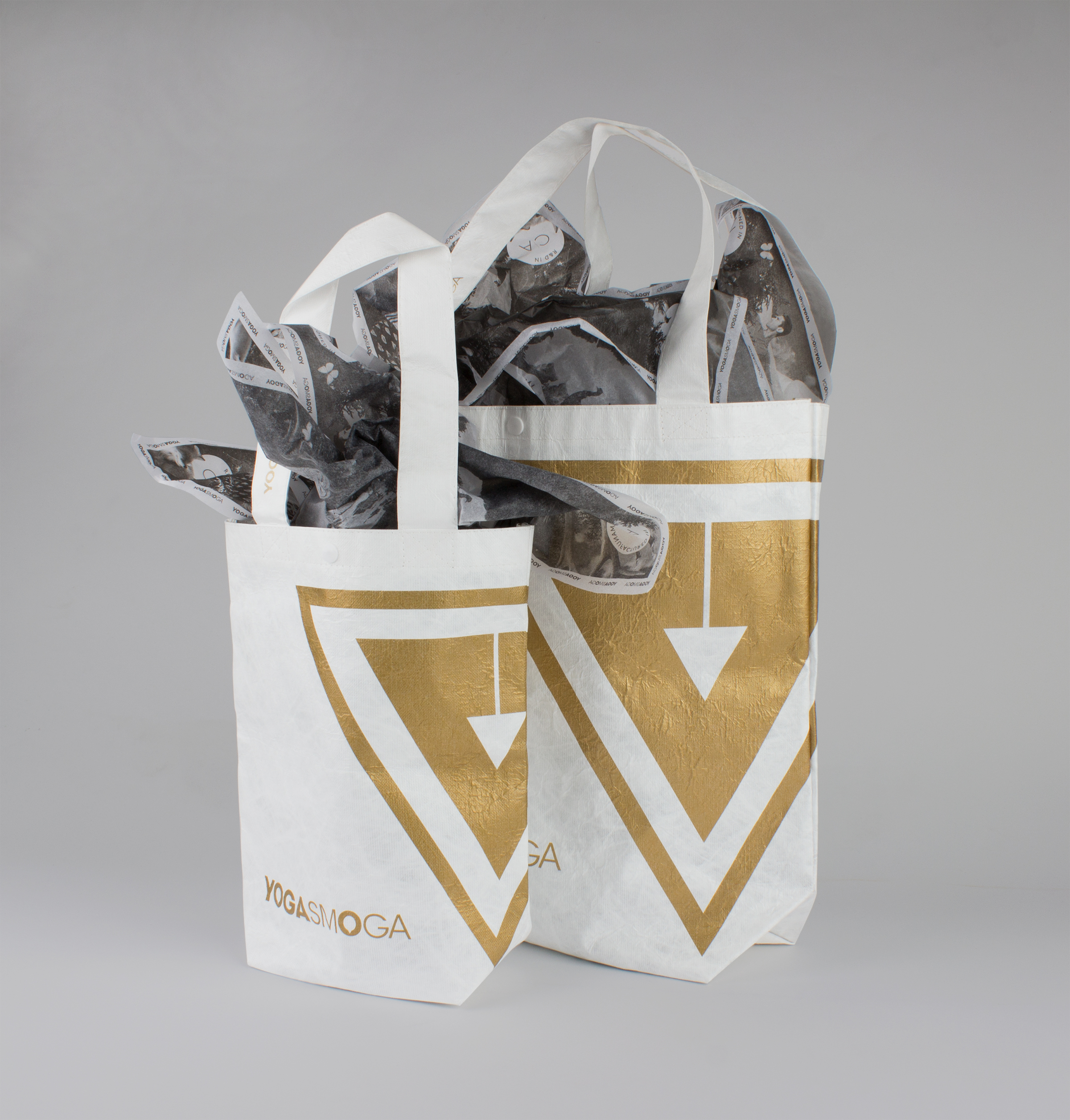 Front of Gold and White YOGASMOGA retail bag in two sizes.