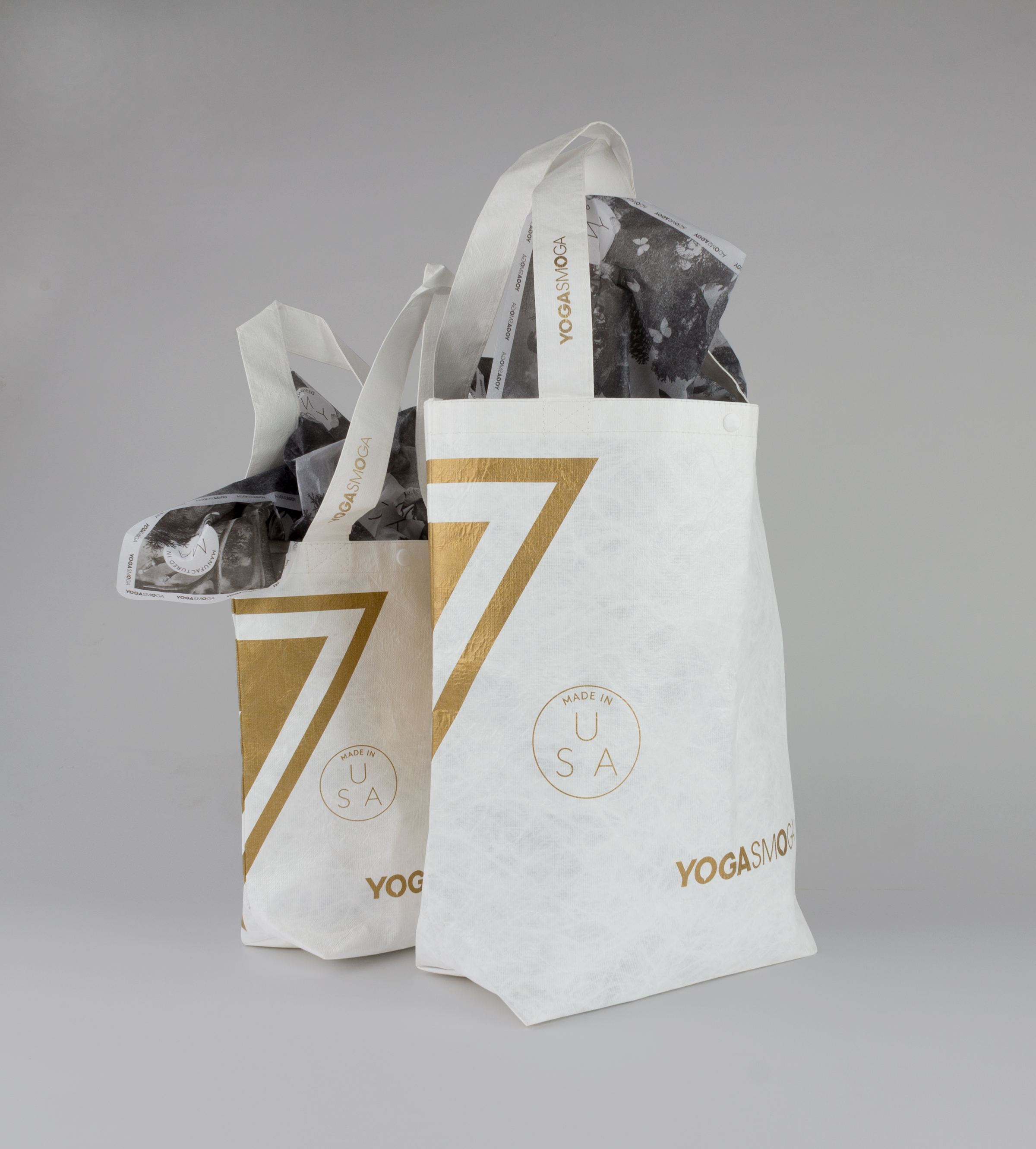 Back of Gold and White YOGASMOGA retail bag in two sizes.
